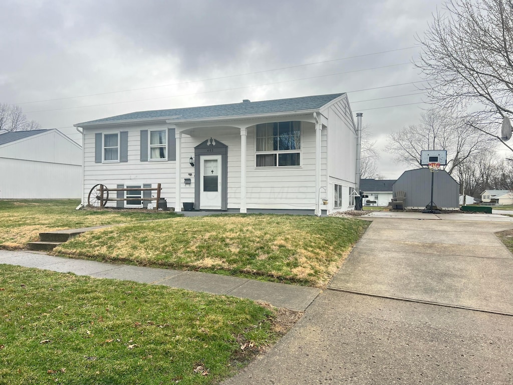 raised ranch with a front yard