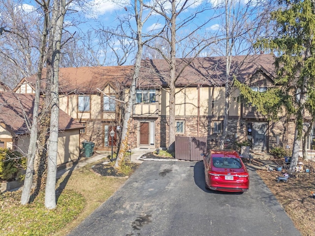 townhome / multi-family property featuring brick siding and a shingled roof