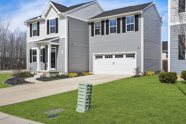 view of front of property featuring a front yard, concrete driveway, and a garage