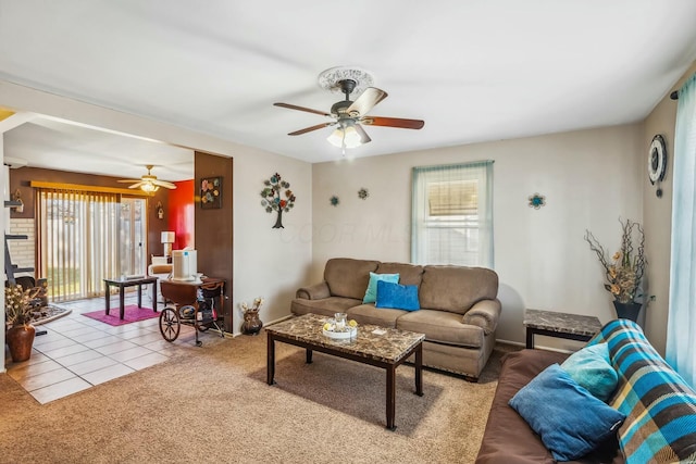 tiled living room with plenty of natural light, carpet flooring, and ceiling fan