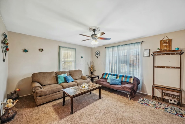 living room with a wealth of natural light, ceiling fan, and carpet floors