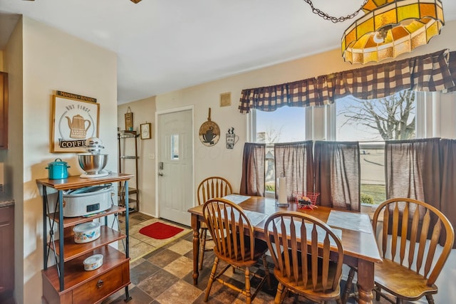 dining space with stone finish floor