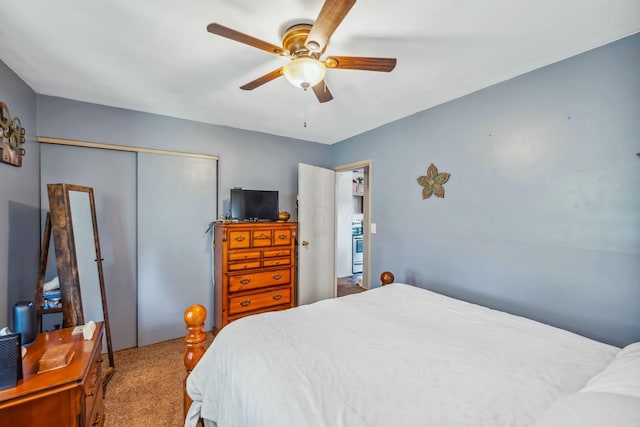 carpeted bedroom featuring a closet and ceiling fan