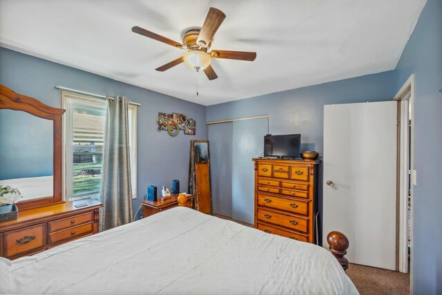 carpeted bedroom with a closet and ceiling fan