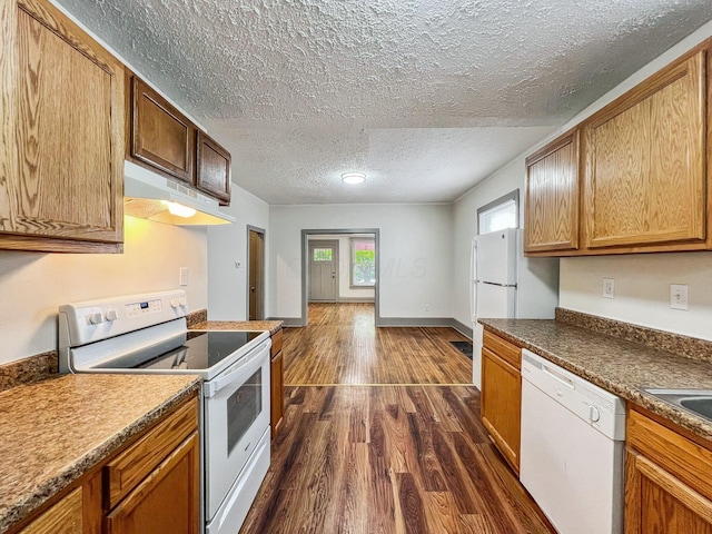 51 Hayden Ave, Columbus, OH 43222 - kitchen featuring white appliances, under cabinet range hood, a textured ceiling, dark wood finished floors, and brown cabinetry