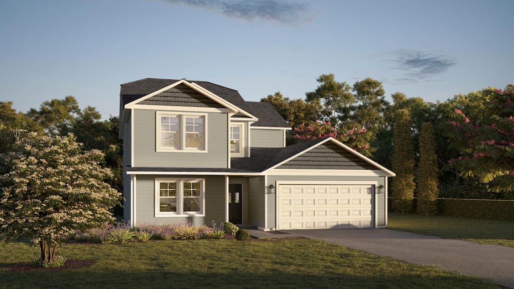 view of front of house with driveway, a front yard, and a garage
