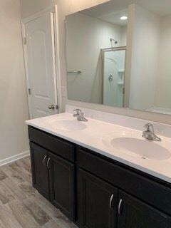 45 Genoa Cir, Commercial Point, OH 43116 - bathroom with a shower stall, double vanity, wood finished floors, and baseboards