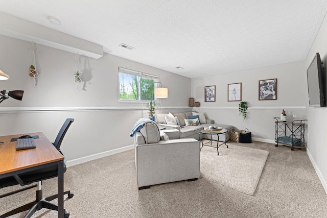 living room featuring carpet, baseboards, and a textured ceiling