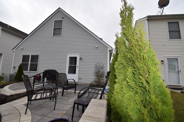 back of house featuring a patio area and central air condition unit