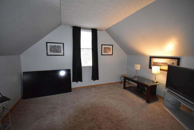 interior space featuring baseboards and lofted ceiling
