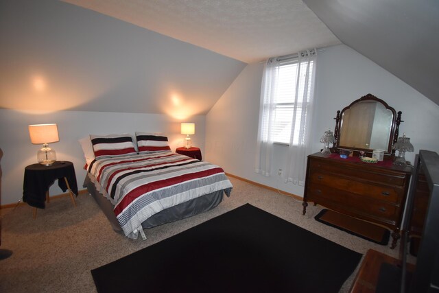carpeted bedroom with baseboards and vaulted ceiling