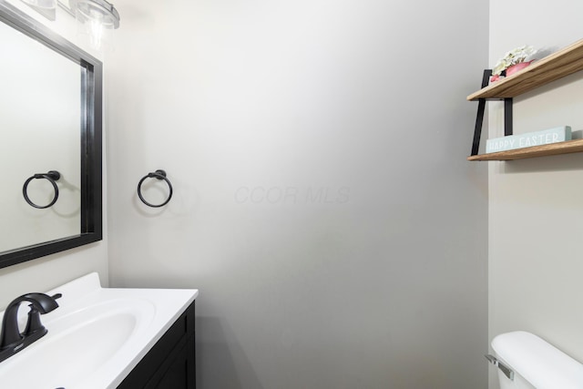 bathroom featuring toilet and vanity