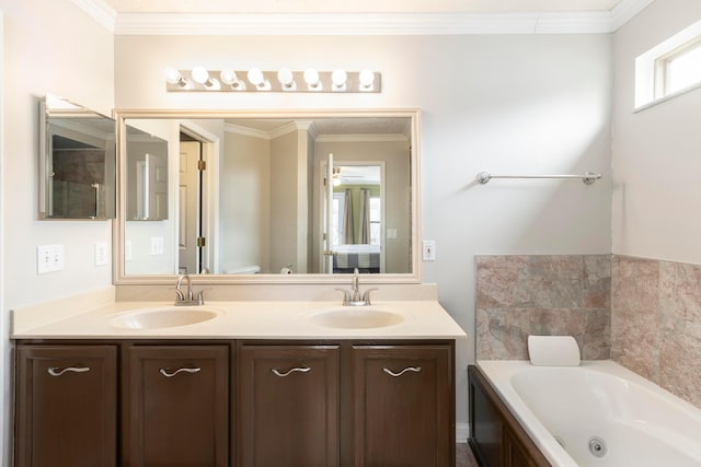 bathroom with double vanity, ornamental molding, a sink, and a tub with jets