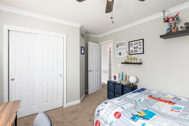 bedroom featuring a closet, a textured ceiling, visible vents, ornamental molding, and light colored carpet