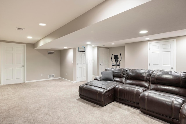 living area featuring baseboards, visible vents, and light colored carpet