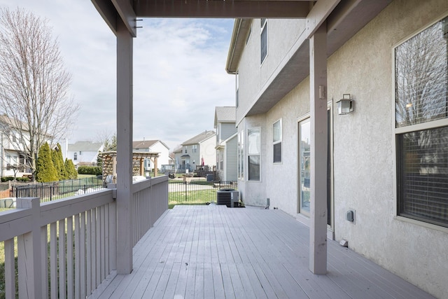 wooden terrace featuring central air condition unit, a residential view, and fence