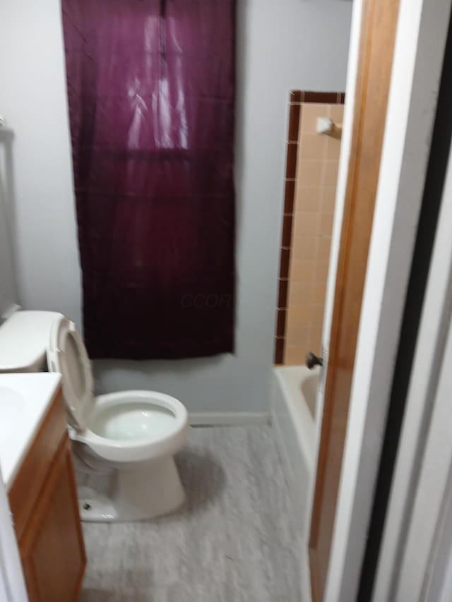 bathroom with vanity, toilet, and baseboards