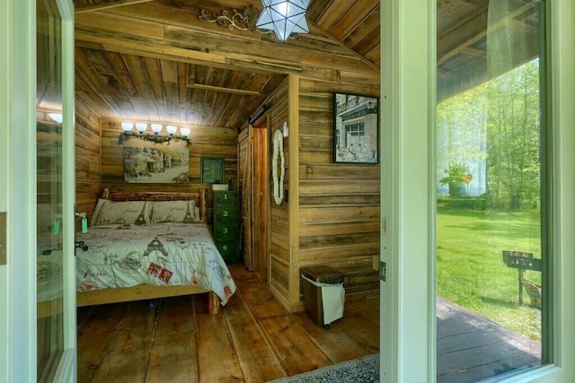bedroom featuring wood ceiling, wooden walls, and hardwood / wood-style flooring
