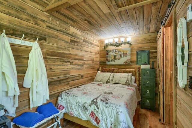 bedroom with wooden walls, wood finished floors, and wooden ceiling