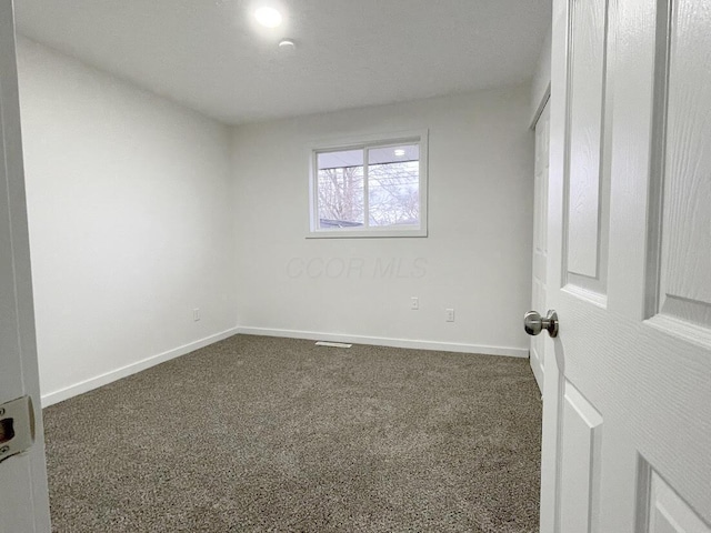 1616 Koebel Rd, Columbus, OH 43207 - unfurnished bedroom featuring dark colored carpet and baseboards