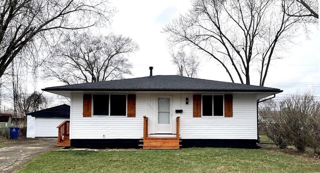 1616 Koebel Rd, Columbus, OH 43207 - view of front of house with an outbuilding, entry steps, a shingled roof, and a front yard
