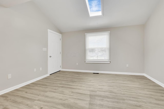 681 Stewart Ave, Columbus, OH 43206 - spare room with light wood-style flooring, vaulted ceiling with skylight, baseboards, and visible vents
