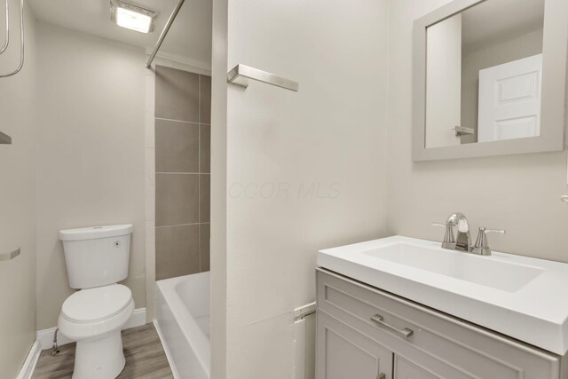 681 Stewart Ave, Columbus, OH 43206 - full bath featuring vanity, toilet, and wood finished floors