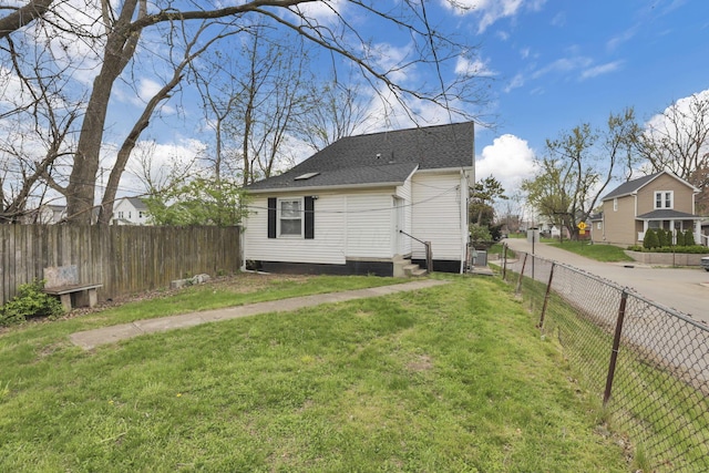 681 Stewart Ave, Columbus, OH 43206 - view of property exterior with a residential view, roof with shingles, entry steps, a fenced backyard, and a yard