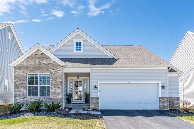view of front of property with brick siding, a garage, driveway, and a shingled roof