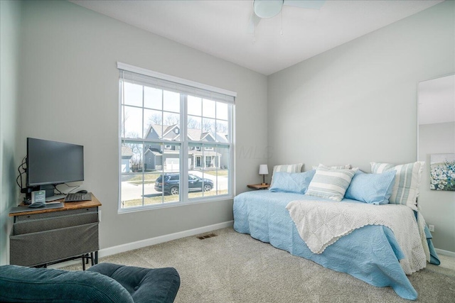 bedroom featuring visible vents, baseboards, carpet, and a ceiling fan