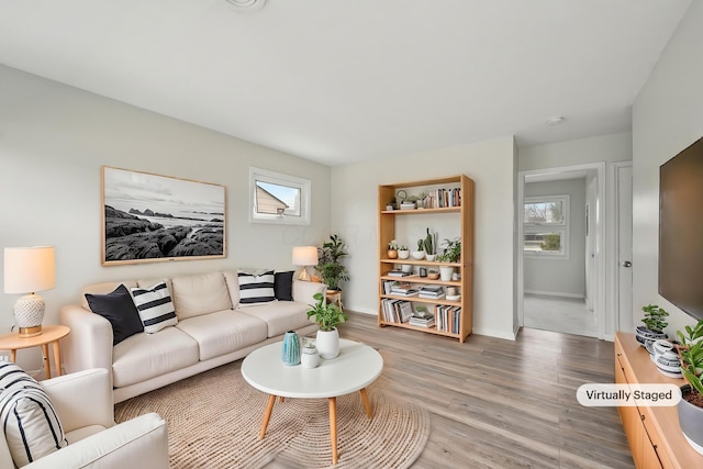 living area with light wood finished floors and baseboards