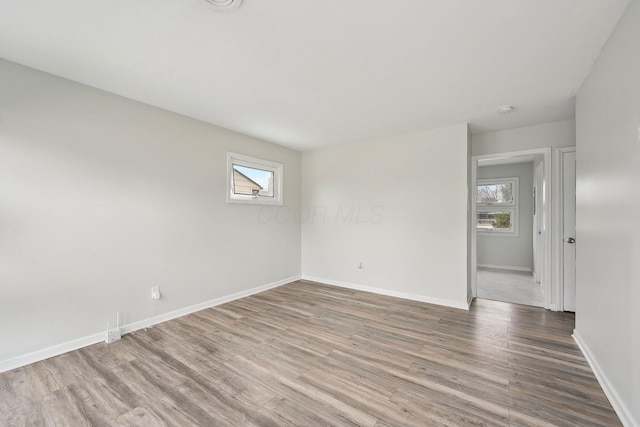 empty room featuring plenty of natural light and wood finished floors