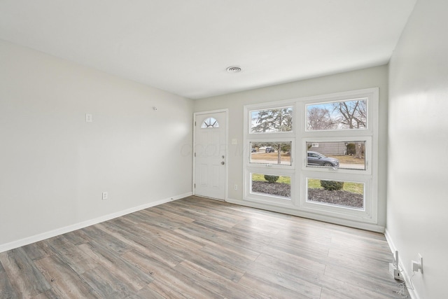 entrance foyer featuring visible vents, a healthy amount of sunlight, and light wood-type flooring