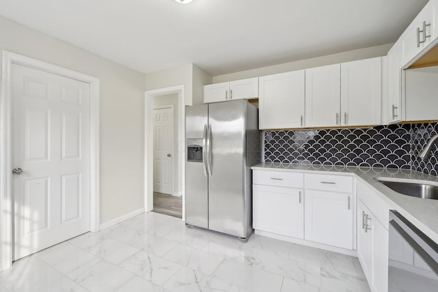 kitchen with white cabinetry, a sink, stainless steel refrigerator with ice dispenser, dishwasher, and marble finish floor