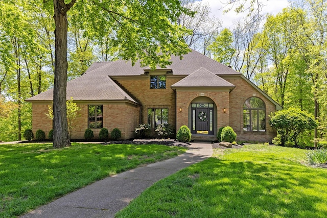 1299 Stratford Woods Dr, Newark, OH 43055 - view of front of house with brick siding, a shingled roof, and a front lawn