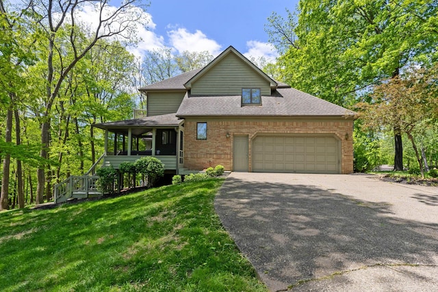 1299 Stratford Woods Dr, Newark, OH 43055 - view of front of home featuring driveway, a shingled roof, a garage, a front lawn, and brick siding