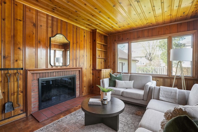 living room with wooden walls, wooden ceiling, a fireplace, and built in shelves