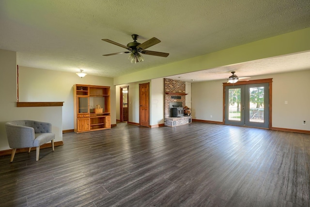 7704 Old Tarlton Pike, Circleville, OH 43113 - unfurnished living room featuring a ceiling fan, baseboards, dark wood finished floors, and a textured ceiling