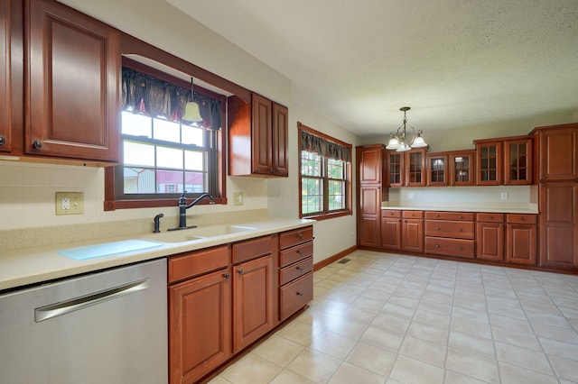 7704 Old Tarlton Pike, Circleville, OH 43113 - kitchen with stainless steel dishwasher, a sink, a chandelier, hanging light fixtures, and light countertops