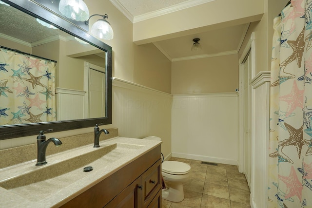 7704 Old Tarlton Pike, Circleville, OH 43113 - bathroom with wainscoting, toilet, vanity, tile patterned flooring, and ornamental molding