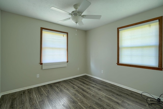 7704 Old Tarlton Pike, Circleville, OH 43113 - spare room with plenty of natural light, dark wood-type flooring, ceiling fan, baseboards, and a textured ceiling