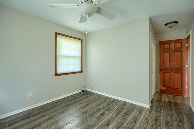 7704 Old Tarlton Pike, Circleville, OH 43113 - unfurnished room with dark wood-type flooring, baseboards, and a ceiling fan