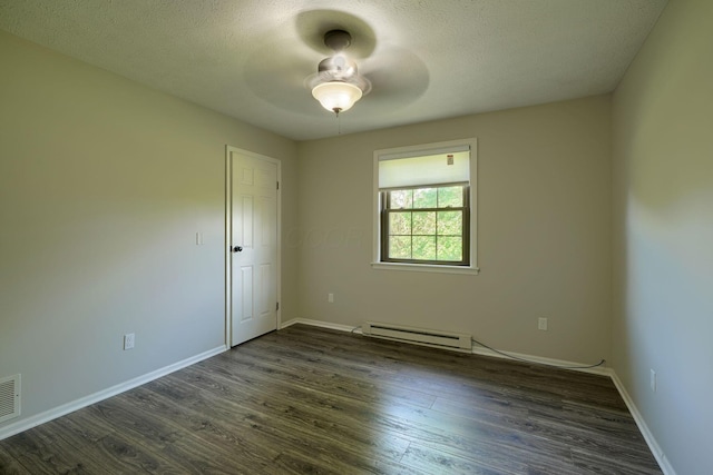 7704 Old Tarlton Pike, Circleville, OH 43113 - empty room with baseboard heating, a ceiling fan, dark wood-style floors, baseboards, and a textured ceiling