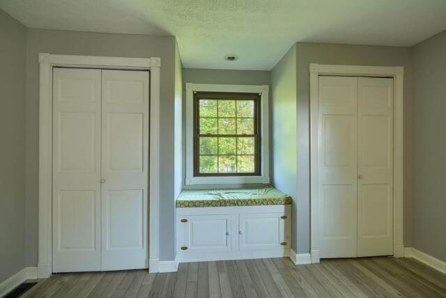 7704 Old Tarlton Pike, Circleville, OH 43113 - unfurnished bedroom with light wood-style flooring, baseboards, and a textured ceiling