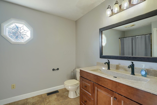 7704 Old Tarlton Pike, Circleville, OH 43113 - bathroom with baseboards, vanity, toilet, and tile patterned flooring