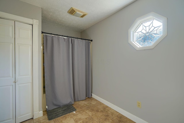 7704 Old Tarlton Pike, Circleville, OH 43113 - full bath featuring baseboards, curtained shower, a textured ceiling, and tile patterned flooring