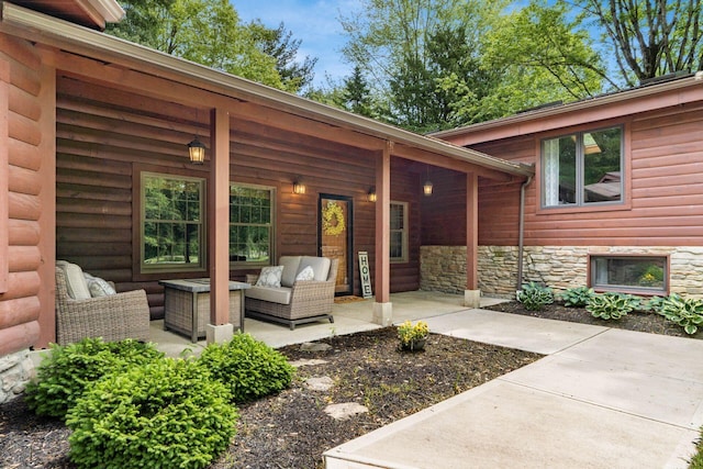 1001 Eckard Rd, Centerburg, OH 43011 - property entrance featuring outdoor lounge area, a patio area, faux log siding, and stone siding