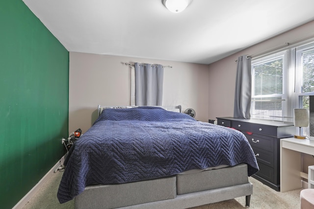 bedroom featuring light colored carpet