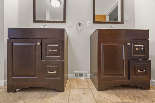 bathroom with vanity, visible vents, and baseboards