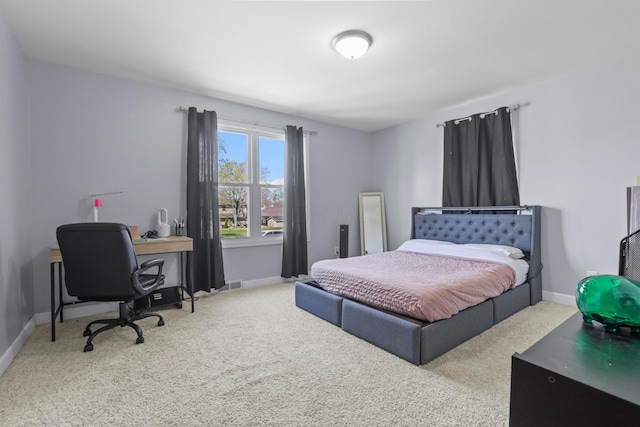 bedroom with carpet floors, baseboards, and visible vents
